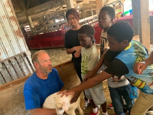 Kids petting a goat