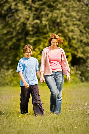 Woman and boy walking outside